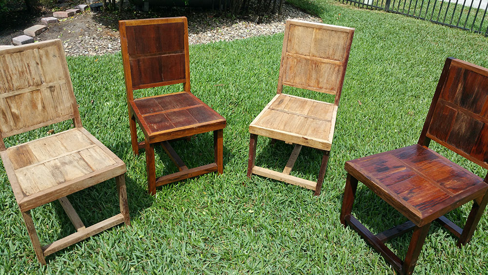 Four wooden chairs that were recently stained and sealed