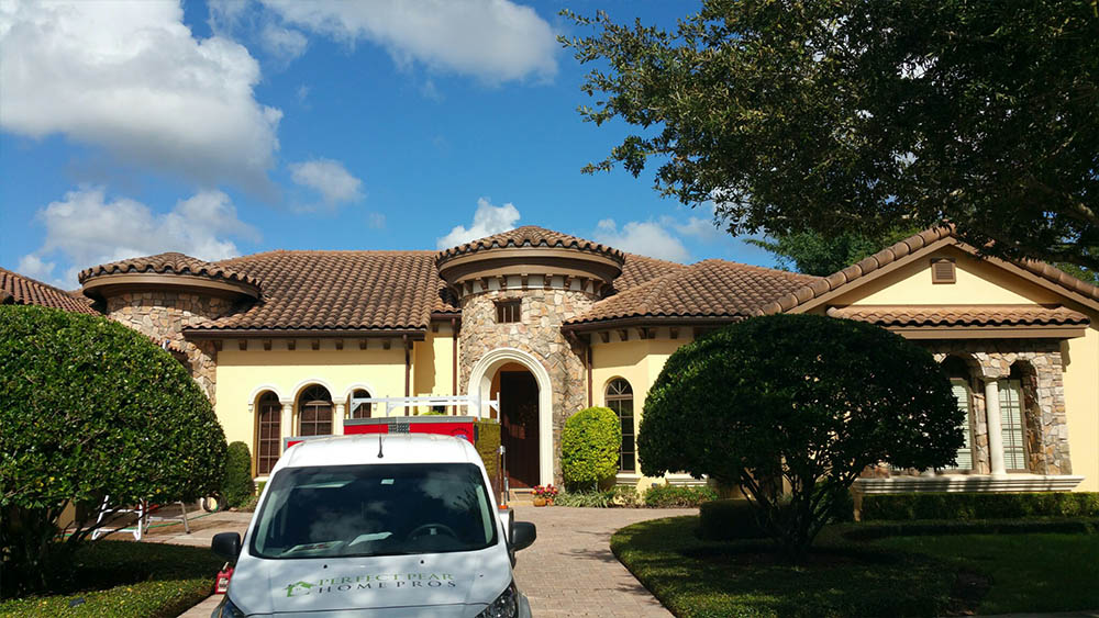 A mansion with the Perfect Pear service vehicle in the driveway